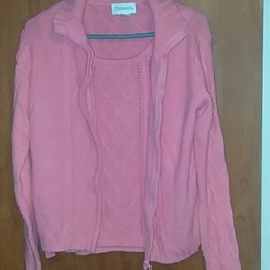 A peach colored sweater set.